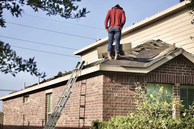 Professional roofer working on a residential roof in Brownbacks